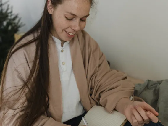 person writing in a journal