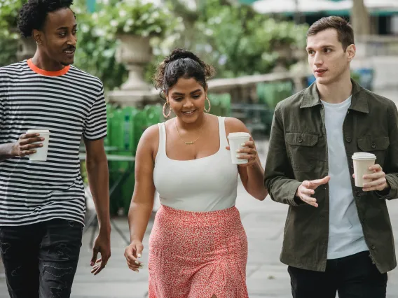 three people walking and talking