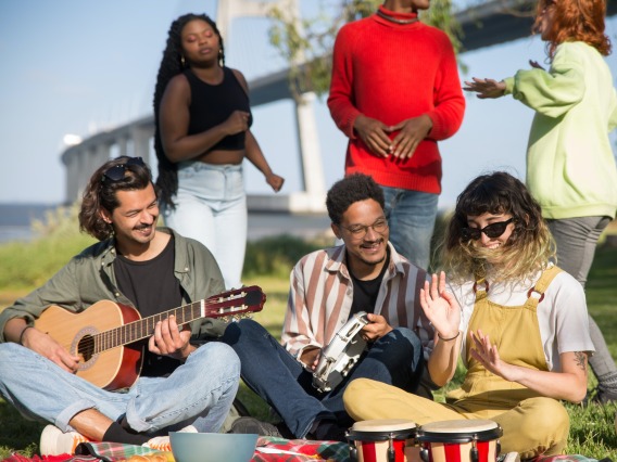 group of people playing musical instruments outside