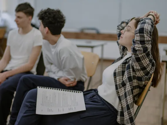 group of students sitting in chairs and talking