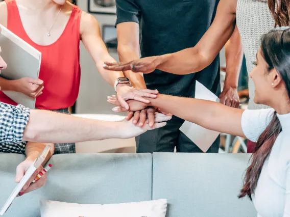 group of people putting their hands together