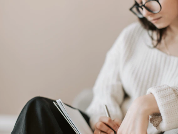 person writing in a journal