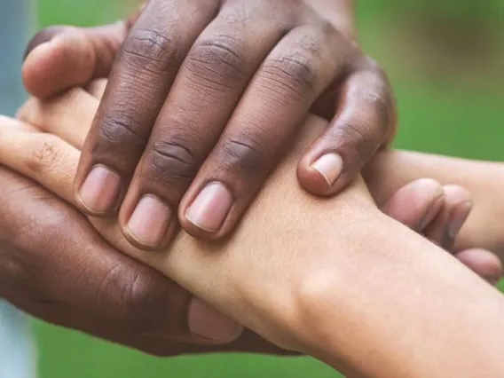 two pairs of hands holding each other