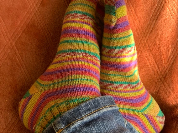 close-up view of two feet wearing colorful socks