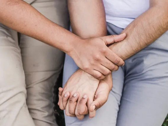 Two people holding hands