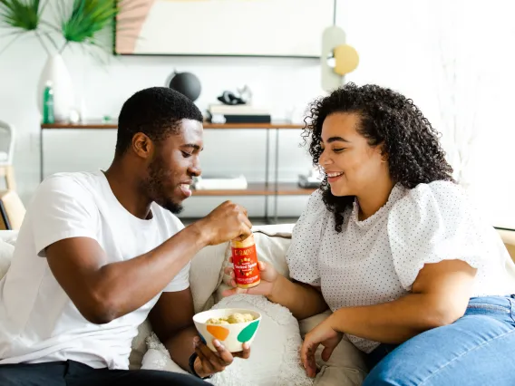 two people eating chips and salsa