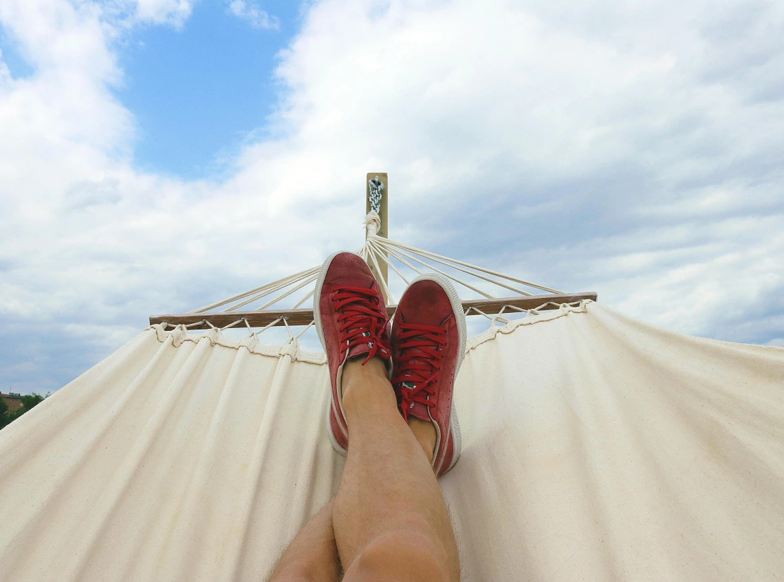 view of someone's feet while lying in a hammock