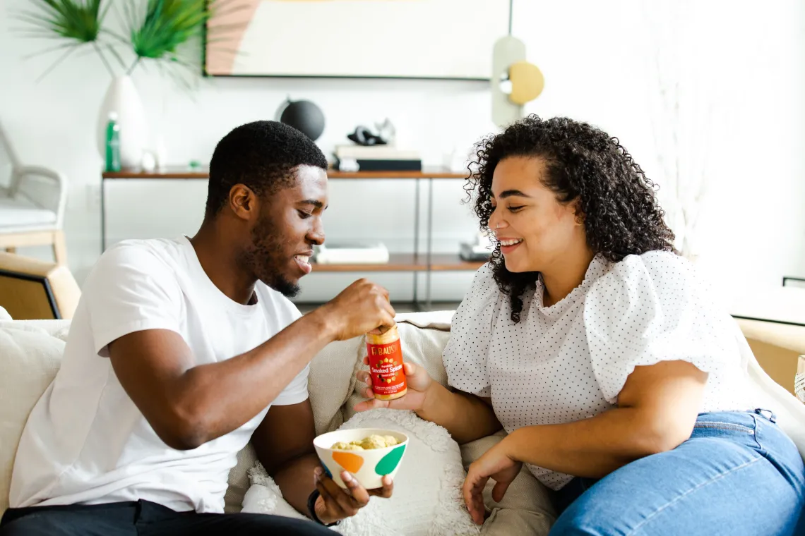 two people eating chips and salsa