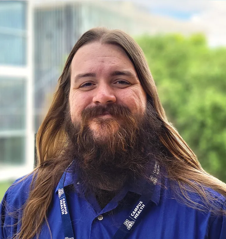 headshot of a person standing outside