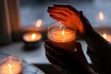 hands holding candle